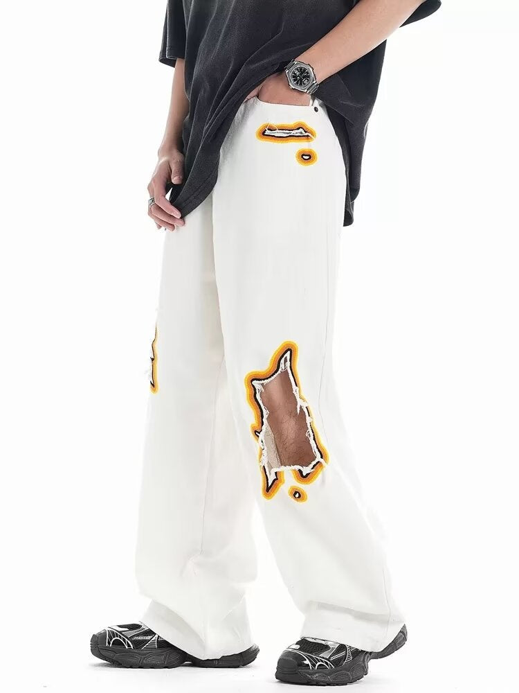 Jeans with hole patches and embroidery Colouronova