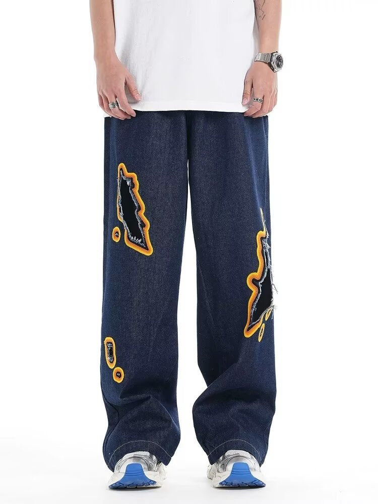 Jeans with hole patches and embroidery Colouronova