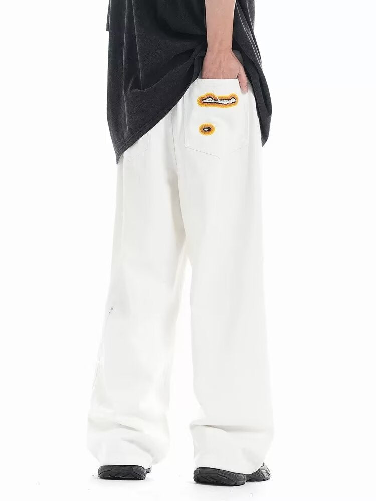 Jeans with hole patches and embroidery Colouronova